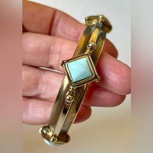 Brass color metallic bangle bracelet with faux turquoise. 3” diameter.